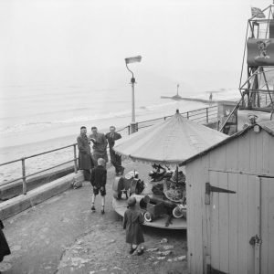 1947 A group of men supervising children on a merry-go-round ride during a Laing staff outing to Whitley